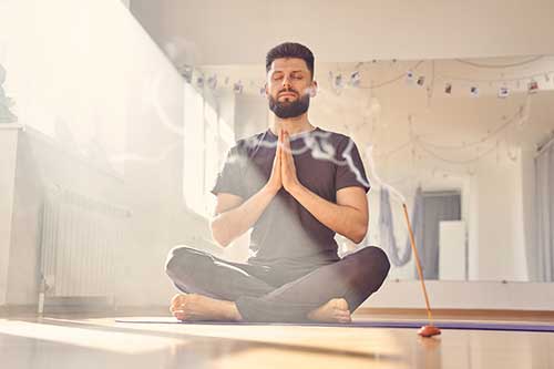 man doing yoga in a yoga studio