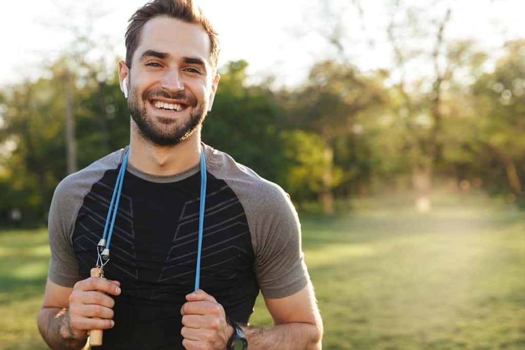 healthy man outside with exercise ropes after quitting drinking