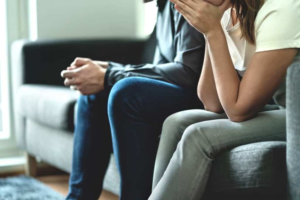 husband and wife sitting on a couch