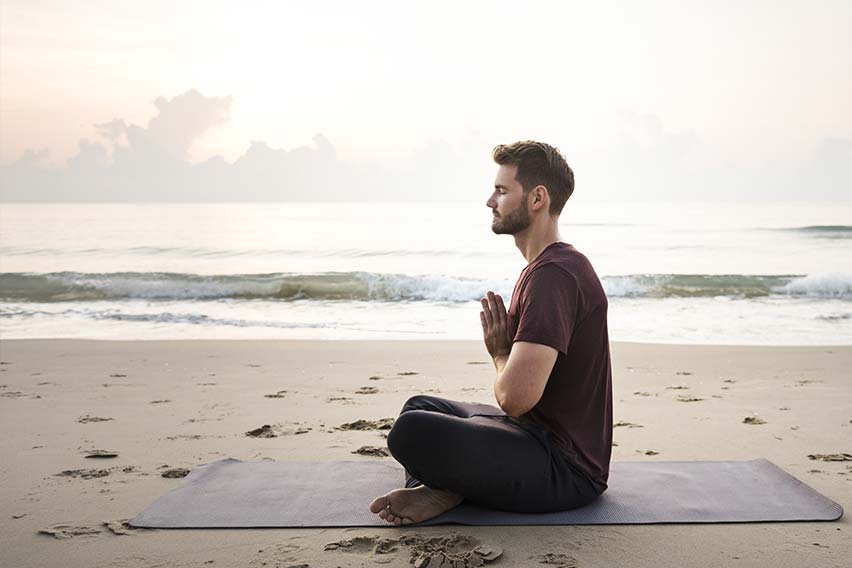 man-practicing-yoga-beach